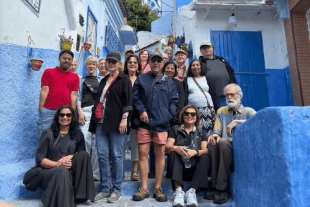 Travelers exploring the famous blue streets of Chefchaouen during a Morocco trip.